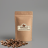 Coffee beans spilling from a bag, showcasing a mockup design with a rustic aesthetic and rich, dark colors.